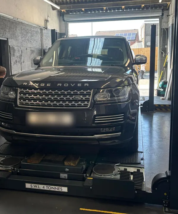 A Range Rover on the four-post lift